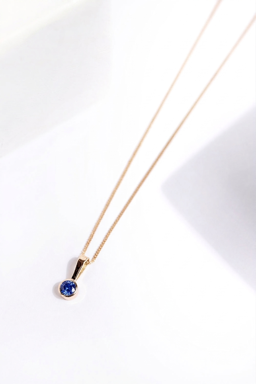 DIJE CHISPA ZAFIRO AZUL ORO 18K (A PEDIDO)